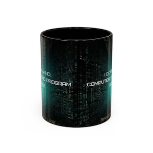May include: Black ceramic coffee mug with a teal and black digital grid design. The mug features white text that reads "COMMAND, END PROGRAM, I COM COMPUTER N". The mug is cylindrical and has a glossy finish.