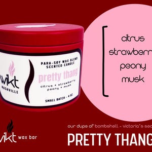May include: A red candle tin with a white label featuring the text "pretty thang" and scent notes: citrus, strawberry, peony, and musk. The candle is a para-soy wax blend and is 4 oz. The brand name "wikt" is also visible.