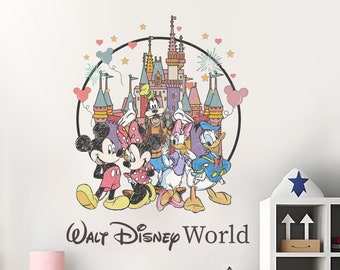 May include: A colorful wall decal featuring Mickey Mouse, Minnie Mouse, Donald Duck, Goofy, and Pluto standing in front of Cinderella's Castle. The decal is surrounded by a circle with stars and hearts. The text "Walt Disney World" is below the characters.