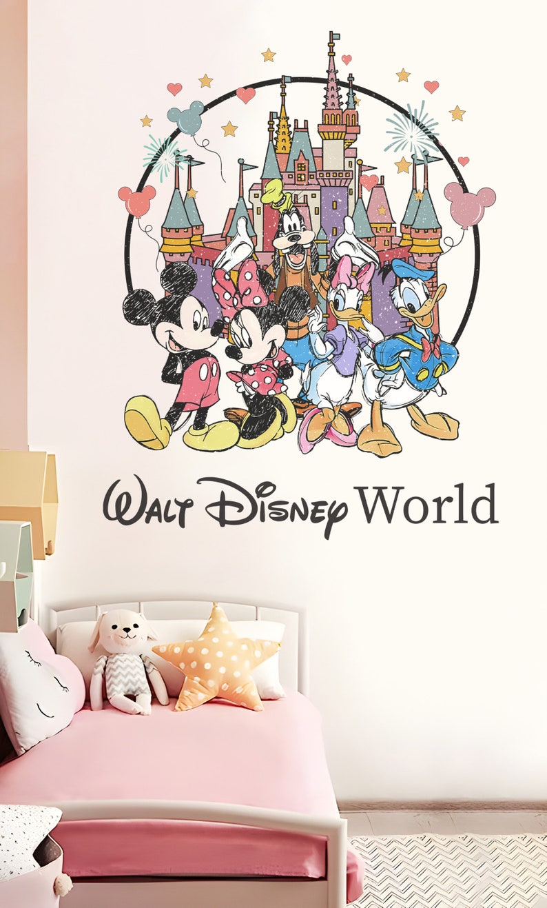 May include: A pink and white bedroom with a white bed and a pink bedspread. The wall has a large decal of Mickey Mouse, Minnie Mouse, Donald Duck, Goofy, and the Disney castle with the text "Walt Disney World".