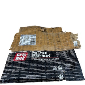 May include: A black and red box with the text "Grip-Rite Collated Fasteners Sujetadores en Espulencia" on it. The box is made of cardboard and has a textured surface.