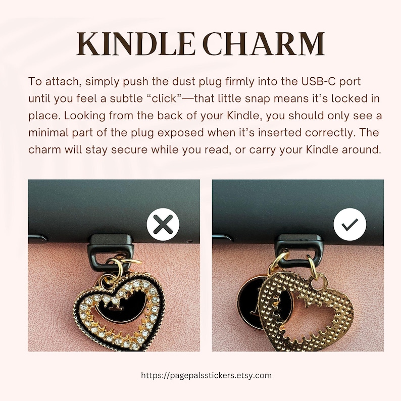 May include: A gold-colored Kindle charm with a heart-shaped design, adorned with rhinestones and a black center. The text "KINDLE CHARM" is displayed at the top of the image, along with instructions on how to attach the charm.
