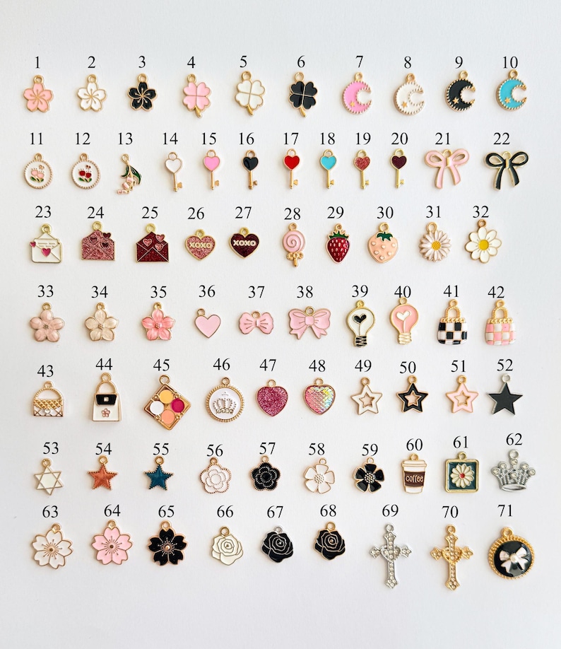 May include: A collection of 71 colorful enamel charms in various shapes, including flowers, hearts, keys, bows, stars, and crosses. Each charm has a gold-tone metal finish and is designed for jewelry making or crafting.