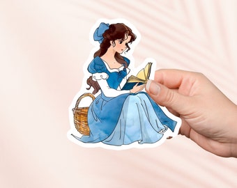 Puede incluir: Una pegatina con una ilustración de acuarela de una mujer con un vestido azul sentada en una cesta de mimbre y leyendo un libro.