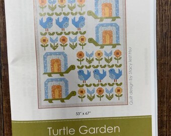 May include: A quilt pattern booklet titled Turtle Garden by Stacy Iest Hsu, featuring a 135 cm x 170 cm quilt design with blue birds, green turtles, and orange flowers. The cover displays the code SIH116 and the text Featuring Animal Park Fun from Moda.