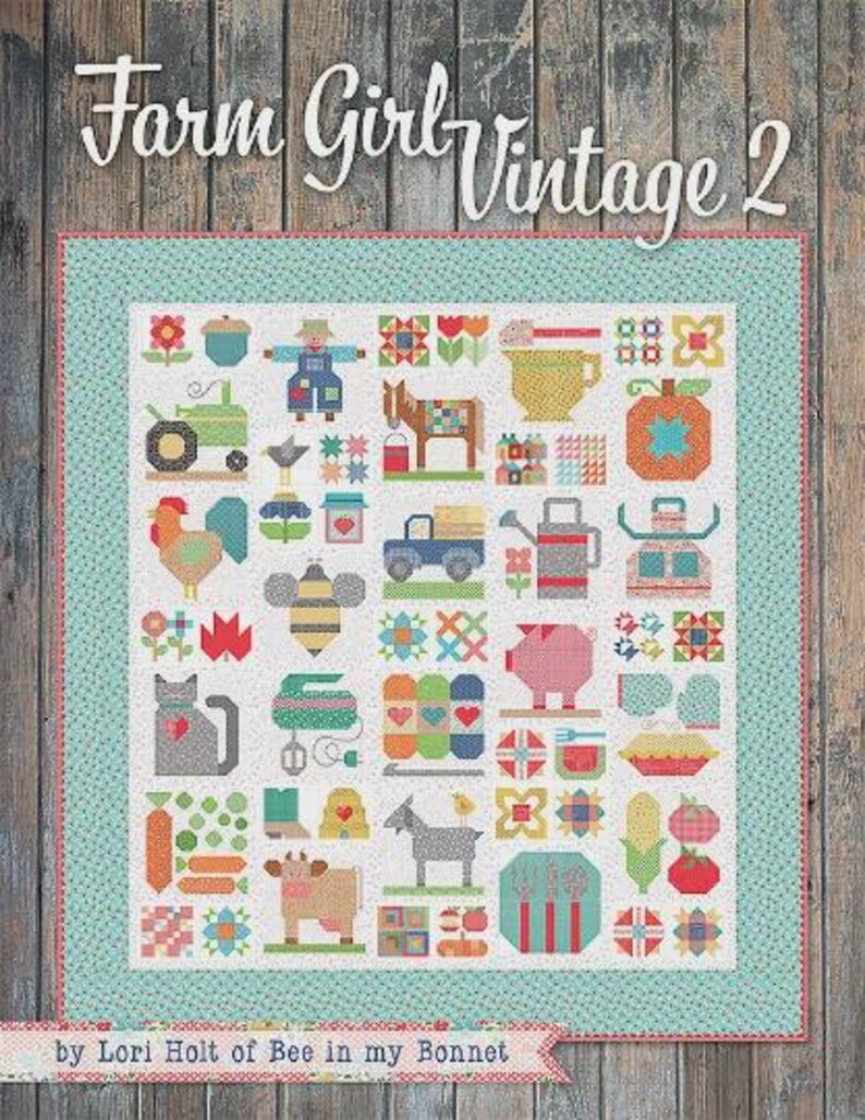 May include: A quilt titled Farm Girl Vintage 2 by Lori Holt of Bee in my Bonnet featuring a grid of colourful patchwork blocks depicting farm animals, produce, and household items, framed by a light blue border with a small white dot pattern.