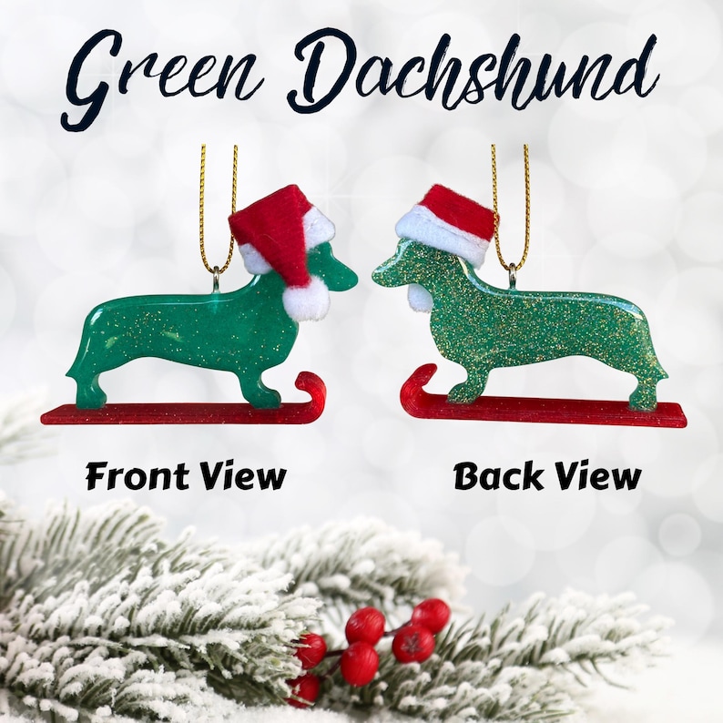 Handmade Dachshund Christmas Ornament made with high quality epoxy resin. The green ornament comes with a gold hanger and red sled with subtle gold glitter highlights on the front and dazzling glitter on the back.
