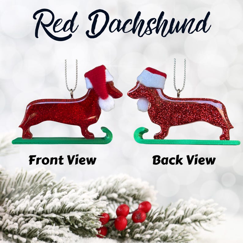 Handmade Dachshund Christmas Ornament made with high quality epoxy resin. The red ornament comes with a silver hanger and green sled with subtle red glitter highlights on the front and dazzling glitter on the back.