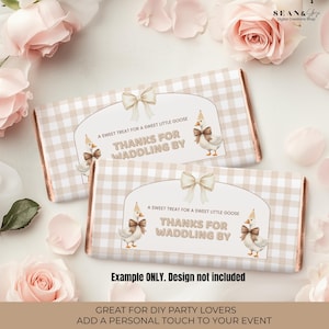 May include: Two chocolate bar wrappers with a beige gingham pattern and a decorative label featuring a goose illustration and the text "THANKS FOR WADDLING BY." The wrappers are surrounded by pink roses and petals.