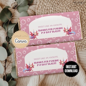 May include: Two pink candy bar wrappers featuring axolotl illustrations and the text "SWEET LIKE AN AXOLOTL THANKS FOR MAKING MY DAY SWEET!". The wrappers have a bubble pattern and are labelled "edit in Canva" and "INSTANT DOWNLOAD".