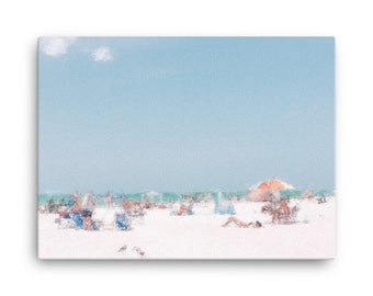 May include: A canvas print depicting a sunny beach scene. The artwork features a light blue sky with a few clouds, a white sandy beach, and a turquoise ocean. People are relaxing under umbrellas and in beach chairs.