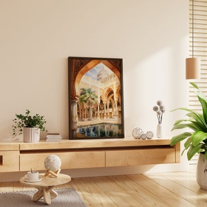 May include: A framed print of a watercolour painting depicting an ornate courtyard with a pool of water in the centre. The courtyard is surrounded by arches and columns, and there is a palm tree in the centre.