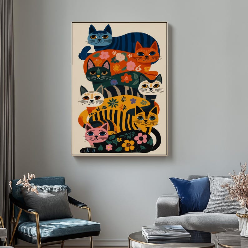 May include: A framed art print featuring a stack of stylized cats in various colors and patterns. The cats have floral and striped designs, with colors including blue, orange, black, yellow, and pink. The artwork has a vintage, mid-century modern aesthetic.