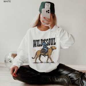 Western Style Sweatshirt Leopard Print Design Retro Cowgirl Crewneck Wild Soul Graphic Vintage Inspired Fashion Country Rodeo Wear Ranch Clothing Collection Casual Outfit Essential Cotton Polyester Blend Comfortable Fit Unisex Adult Sizing