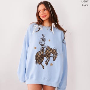 Comfortable Western Pullover Cowboy Style Sweatshirt Retro Checkered Design Bucking Bronco Graphic Cotton Polyester Blend Crewneck Top Rodeo Fashion Statement Country Lifestyle Apparel Ranch Wear Collection Casual Western Outfit Vintage