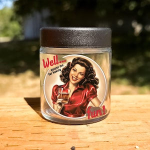 May include: A clear glass jar with a black lid and a vintage-style illustration of a woman in a red dress holding a glass of whiskey. The illustration has the text "Well... excuse me for having fun!"