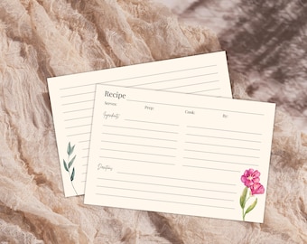 May include: Two cream-colored recipe cards with lined spaces for recipe details. One card features a watercolor floral design with pink flowers and green leaves. The other card has a green leaf design. The word "Recipe" is at the top.