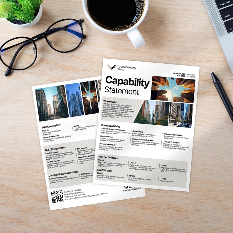 May include: Two white Capability Statement documents with text and images, next to a cup of coffee, a small plant, a pen, and glasses. The documents include sections like "Who We Are" and "Core Capabilities."