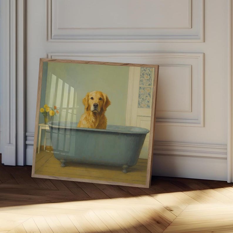 May include: A framed print featuring a golden retriever dog sitting in a blue bathtub. The dog has a light brown coat and is looking directly at the viewer. The background includes a light green wall, a white door, and a small table with yellow flowers.