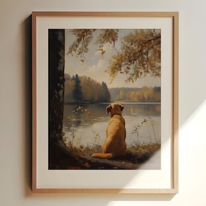 May include: A framed painting of a golden retriever dog sitting by a lake, looking out at the water. The dog is in the foreground, with a forest and lake in the background.