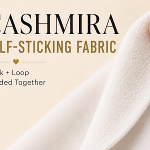 May include: A white fabric labeled CASHMIRA SELF-STICKING FABRIC with the text Hook + Loop Bonded Together. The material has a soft, fuzzy texture on one side and a smooth, flat surface on the other, showing the two layers joined together.