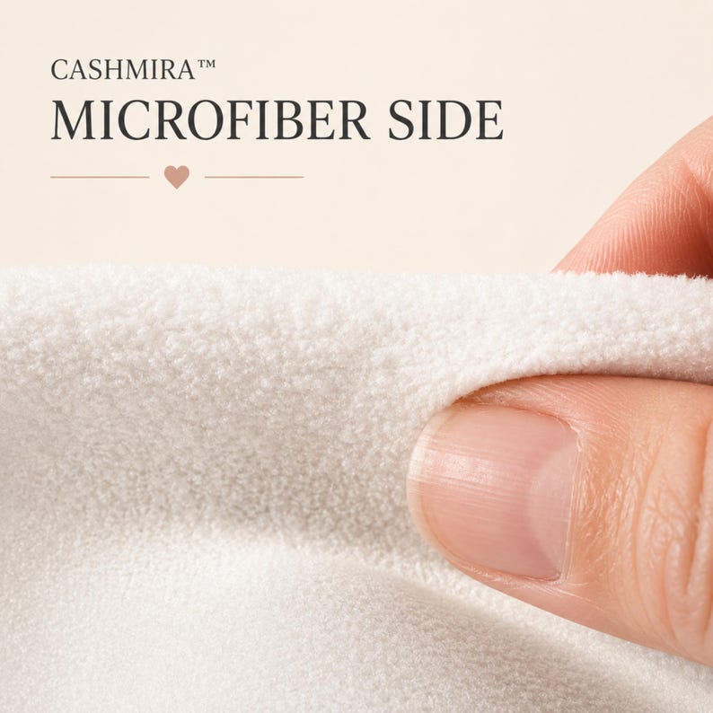 May include: A close-up view of a white microfiber fabric with a soft, textured surface. The text CASHMIRA MICROFIBER SIDE is printed in dark lettering above the fabric, accompanied by a small heart icon and horizontal lines.