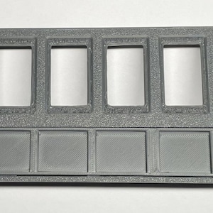 May include: Gray plastic panel with six rectangular cutouts for switches and six rectangular cutouts for indicator lights.