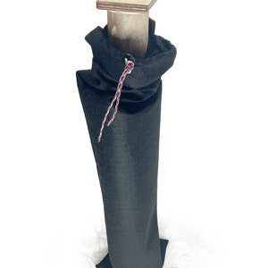 May include: A black fabric bag with a drawstring closure, containing a wooden dowel with a square wooden top.