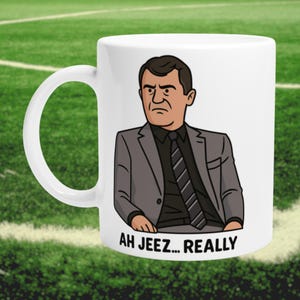 May include: White ceramic mug with a cartoon illustration of a man in a grey suit and black tie. The text "AH JEEZ... REALLY" is printed below the illustration. The mug has a white handle.