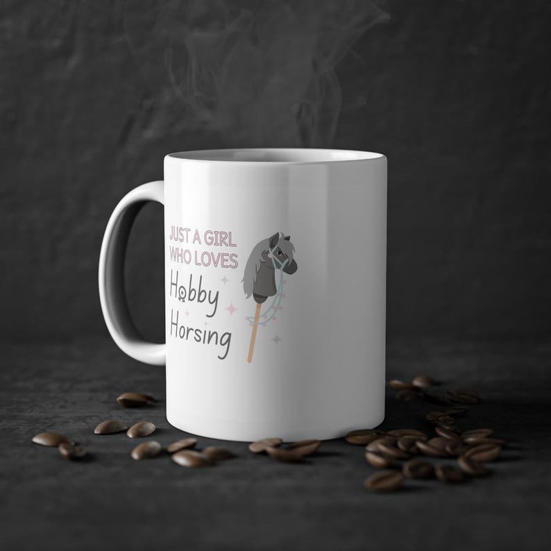 May include: White ceramic mug with a black and gray hobby horse illustration and the text "Just a girl who loves Hobby Horsing".