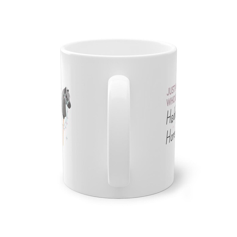 May include: White ceramic mug with a black and white horse illustration and the text "Just a girl who loves horses" in pink.