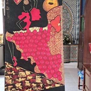 May include: A painting of a flamenco dancer wearing a red dress and holding a fan, with a guitar and musical notes on a black background.