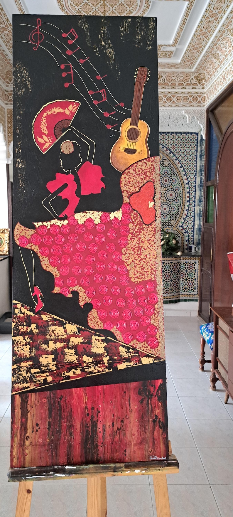 May include: A painting of a flamenco dancer wearing a red dress and holding a fan, with a guitar and musical notes on a black background.