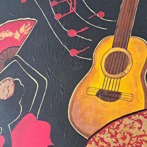 May include: A black canvas painting featuring a red and gold flamenco dancer, a yellow acoustic guitar, and red musical notes on a white background.