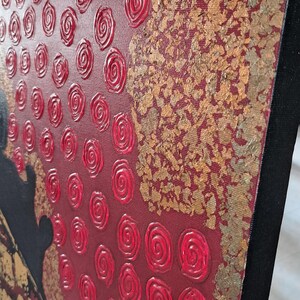 May include: Abstract painting on canvas with a red background and gold accents. The painting features a textured design of red swirls and gold leaf.
