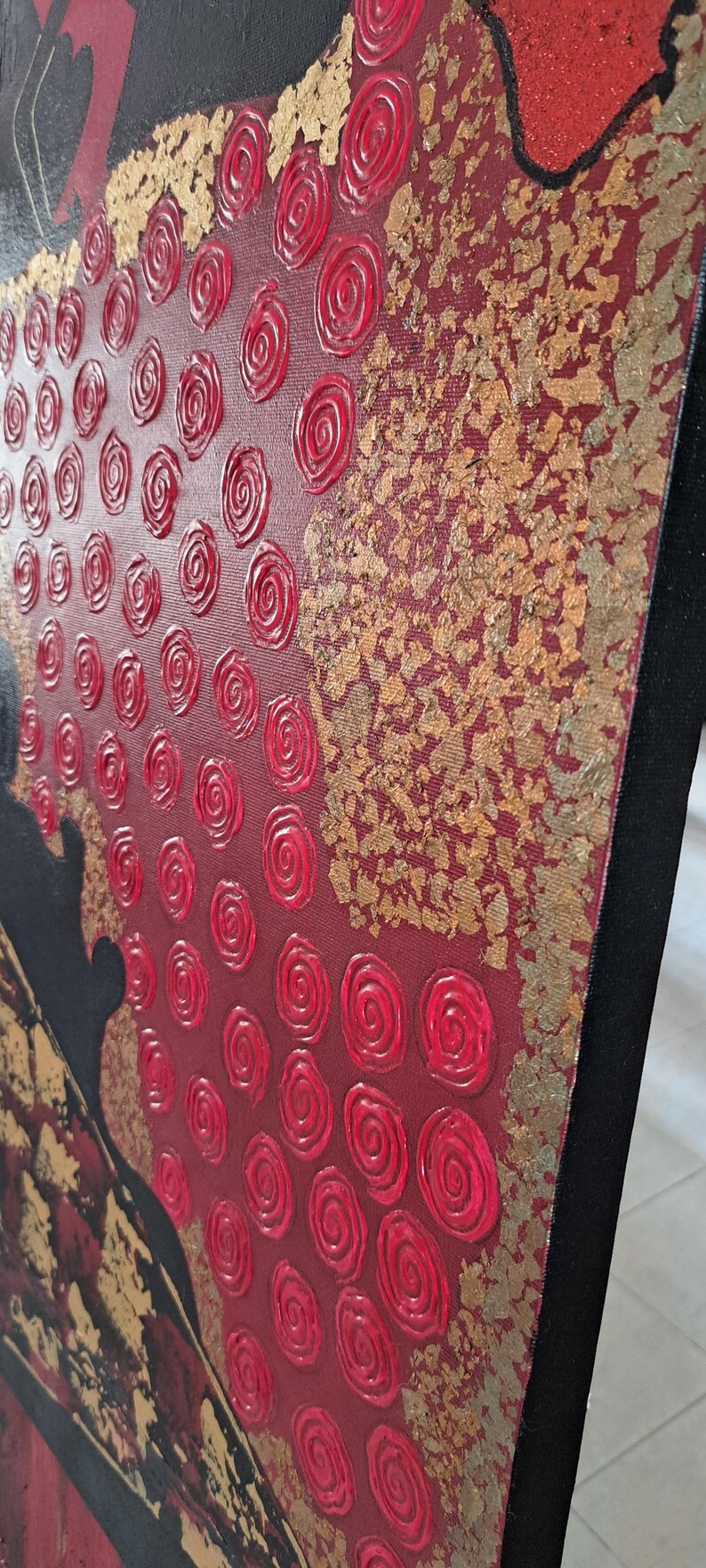 May include: Abstract painting on canvas with a red background and gold accents. The painting features a textured design of red swirls and gold leaf.