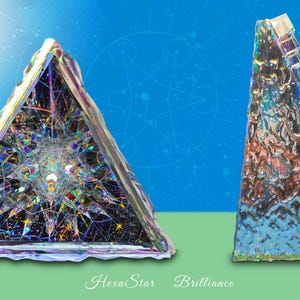 May include: Two iridescent glass sculptures, one shaped like a pyramid with a starburst design and the other a tall, narrow prism. The pyramid is labeled "Hexa Star" and the prism is labeled "Brilliance".