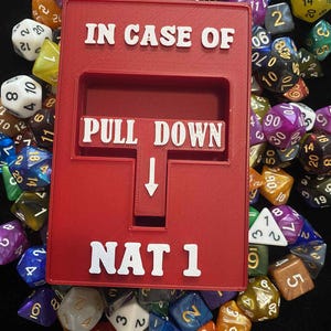 May include: A red box with white text that reads "IN CASE OF PULL DOWN NAT 1" is surrounded by a variety of colorful polyhedral dice. The dice are in various shapes and sizes, with numbers on each face.