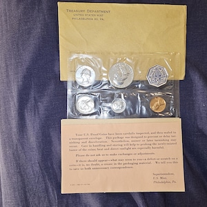 May include: A set of six silver US Proof Coins in a clear plastic envelope. The coins are sealed in individual plastic sleeves. The envelope is labeled with the Treasury Department, United States Mint, Philadelphia 30, PA. The envelope also includes instructions on how to care for the coins.