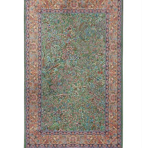 May include: A rectangular green rug with a detailed floral pattern and a border of various colors. The rug has gray tassels along the top edge. The intricate design includes shades of green, blue, red, and orange, creating a vibrant and decorative piece.