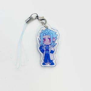 May include: A clear acrylic charm featuring a cartoon character with blue hair, red eyes, and a lab coat, holding a syringe. The charm is attached to a silver-colored clasp and a light blue lanyard.