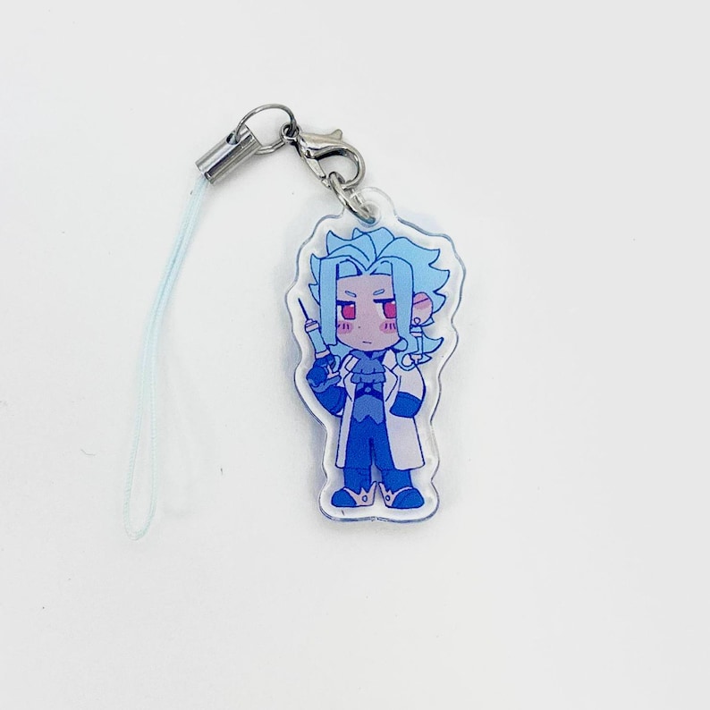 May include: A clear acrylic charm featuring a cartoon character with blue hair, red eyes, and a lab coat, holding a syringe. The charm is attached to a silver-colored clasp and a light blue lanyard.