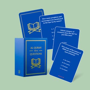 May include: A blue trivia game box and cards with gold text and illustrations. The box reads "AL-QURAN TRIVIA QUESTIONS". The cards pose questions about the Qur'an, with multiple-choice answers. The game is designed for educational purposes.