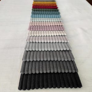 High-quality bold striped upholstery fabric, available in 21 colors. Durable and perfect for elegant furniture. Sold by the yard.