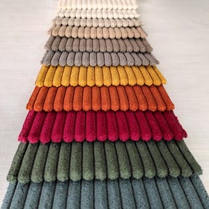 High-quality bold striped upholstery fabric, available in 21 colors. Durable and perfect for elegant furniture. Sold by the yard.
