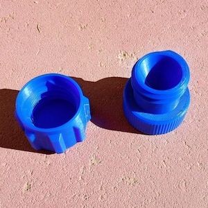 May include: A white ceramic mug with a black handle and the text "But First, Coffee" in a bold, black font. The mug is set against a blurred background, suggesting a cozy setting.