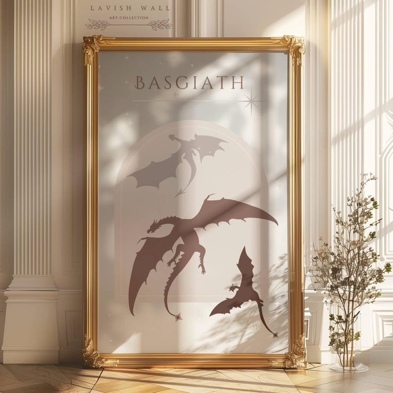 May include: A gold framed print with the word "BASGIATH" in a light brown font. The print features three silhouettes of dragons in shades of brown and gray against a light blue background.
