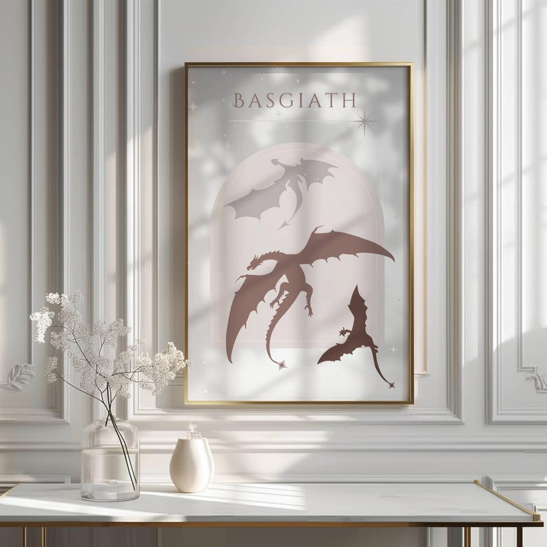 May include: A printable art print with a light pink background featuring three black silhouettes of dragons with the word "Basgiath" at the top.