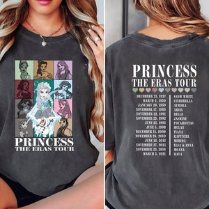 May include: A black t-shirt with a graphic of Disney princesses and the text "Princess The Eras Tour". The back of the shirt has a list of dates and princess names.
