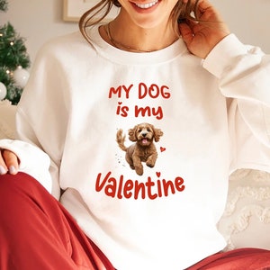 May include: White sweatshirt with the text "My dog is my Valentine" and a cartoon image of a brown dog with red hearts.